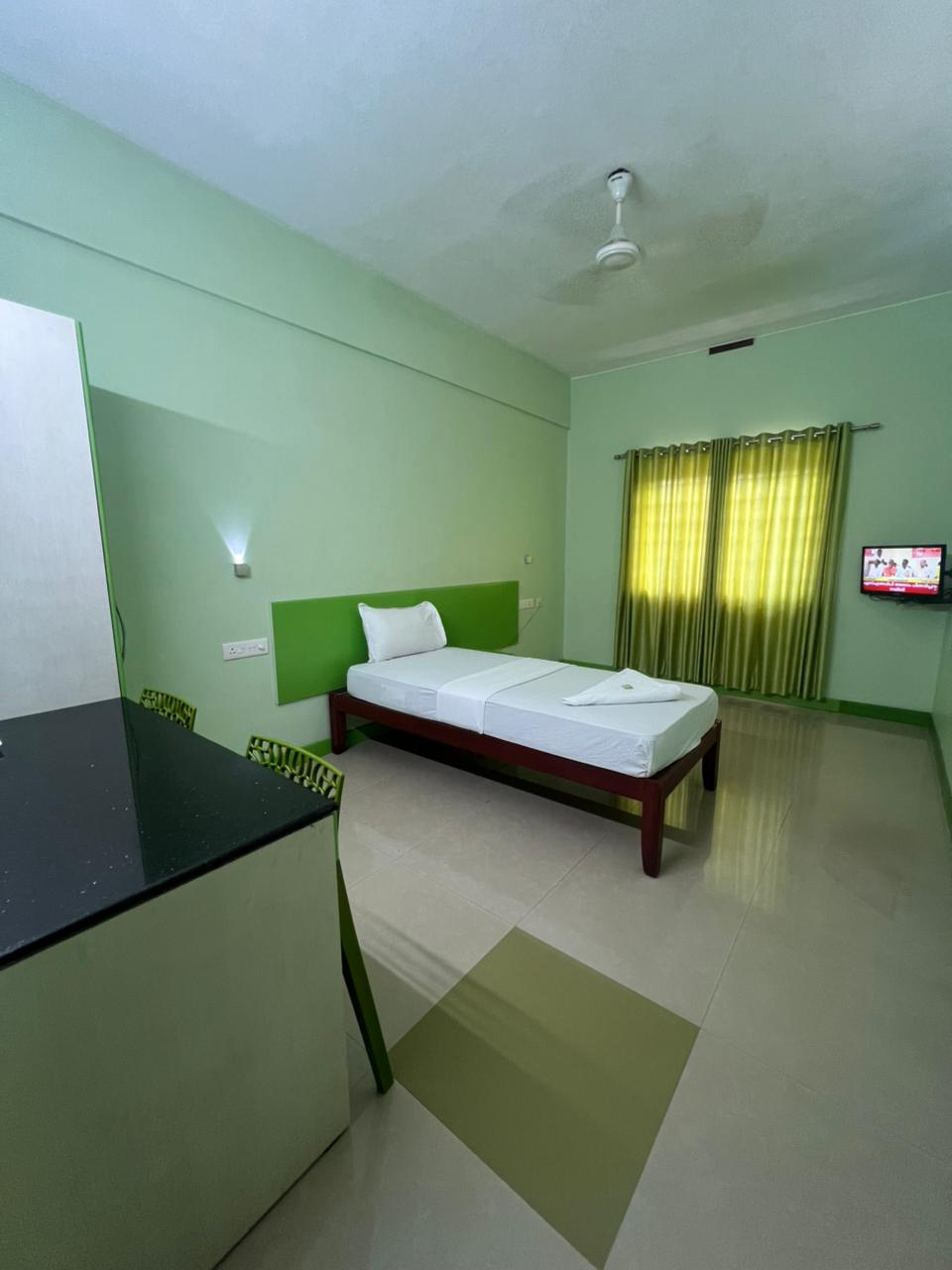 Single room with study table and TV